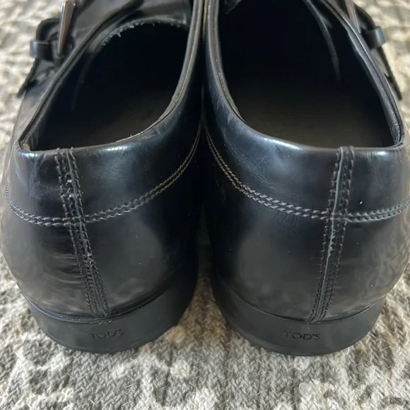 Tod’s black buckle loafers